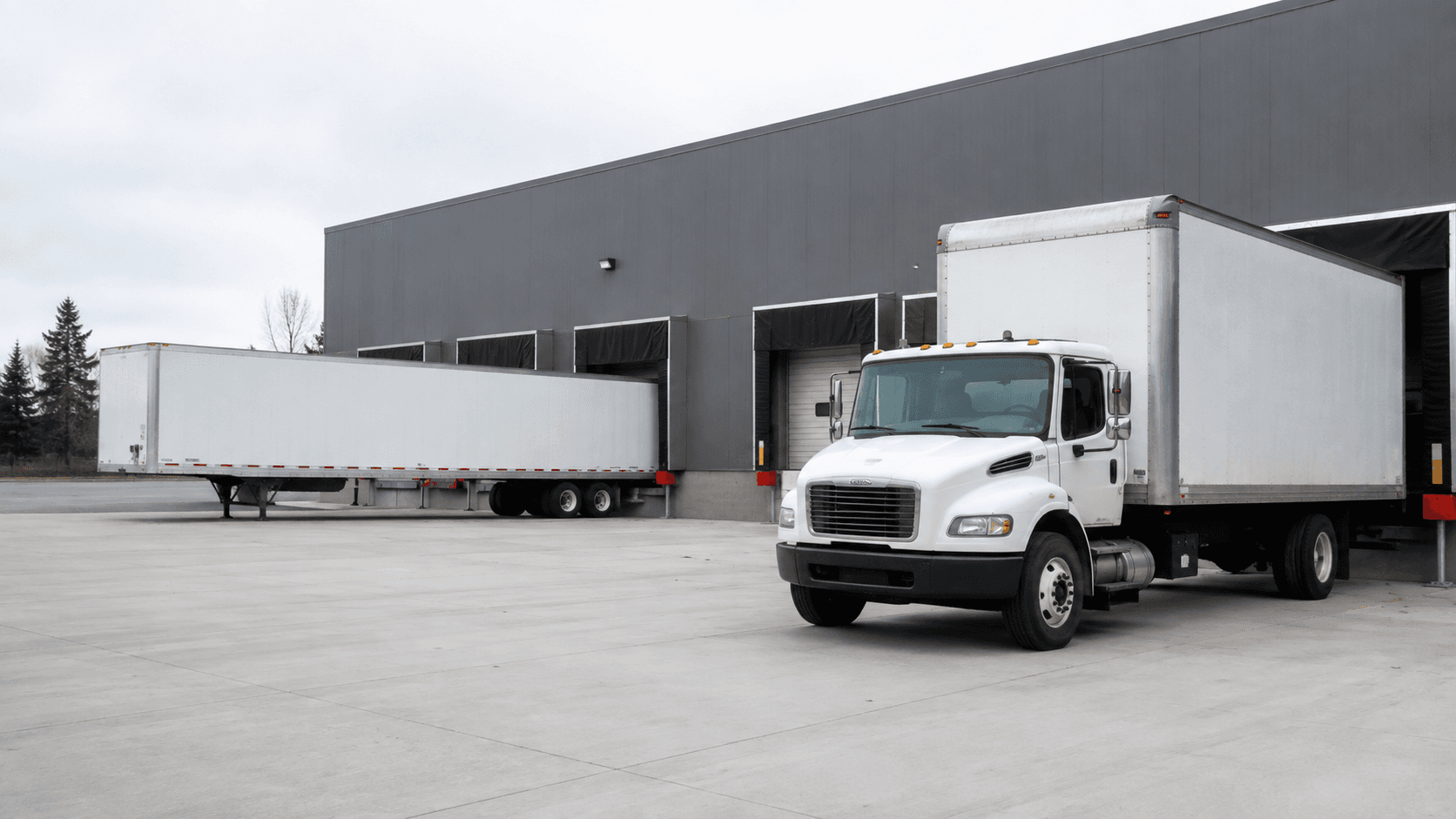 Commercial straight box truck parked at distribution terminal